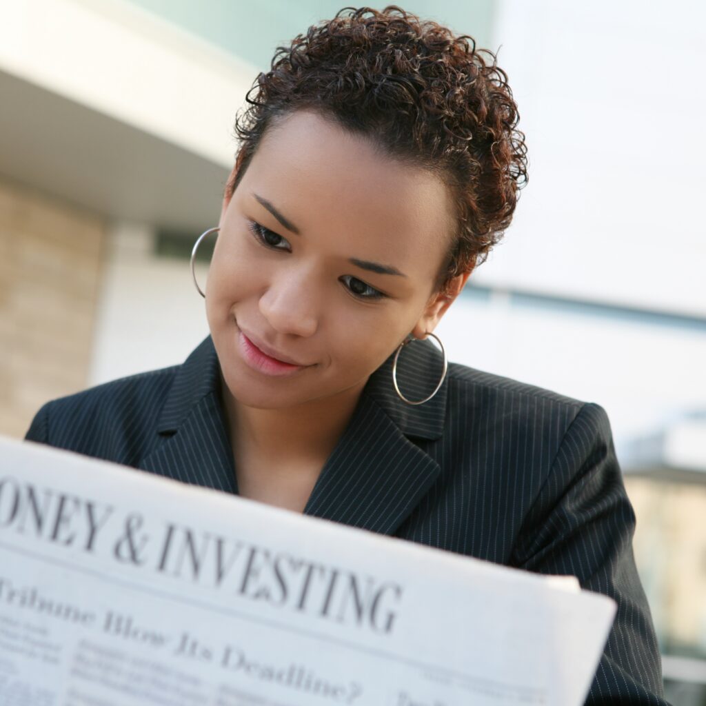 A girl looks at a newspaper