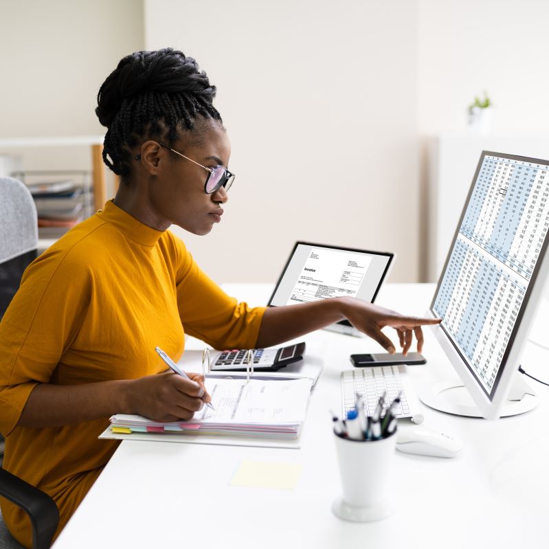 African Professional Chartered Accountant Woman examining spreadsheets on a computer