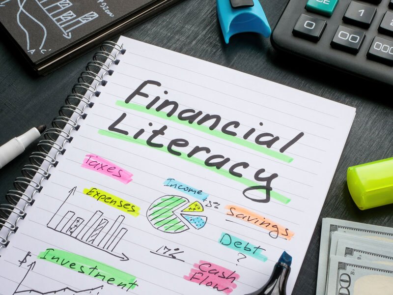 Financial literacy and financial education concept. A Notebook with marks about financial literacy.