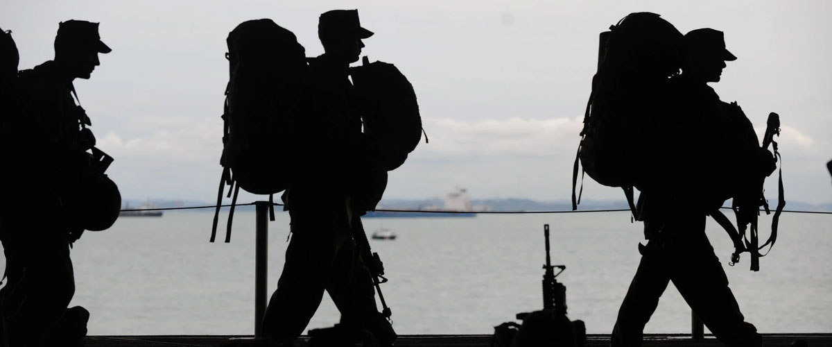 Soldiers marching in silhouette