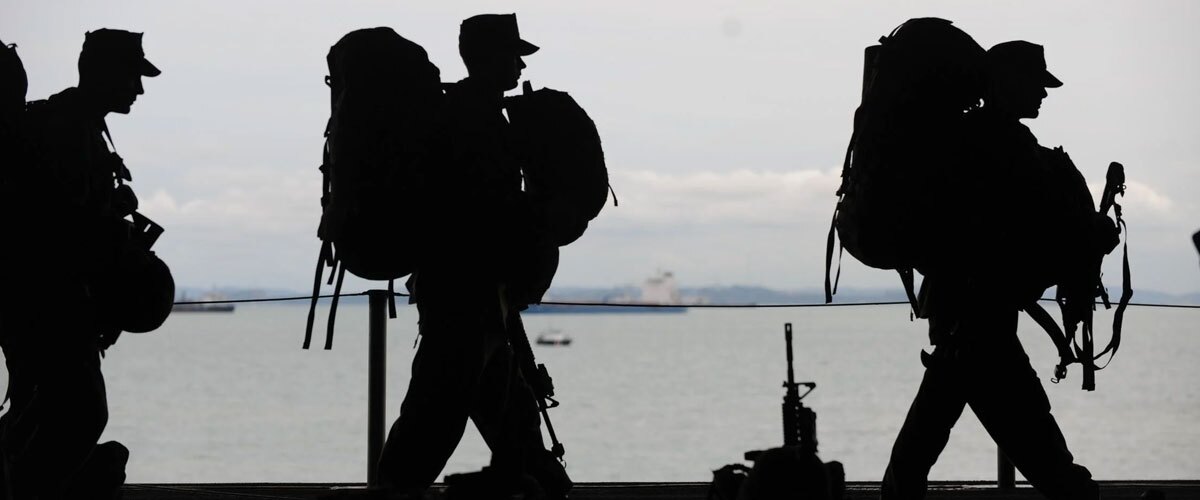 Soldiers marching in silhouette