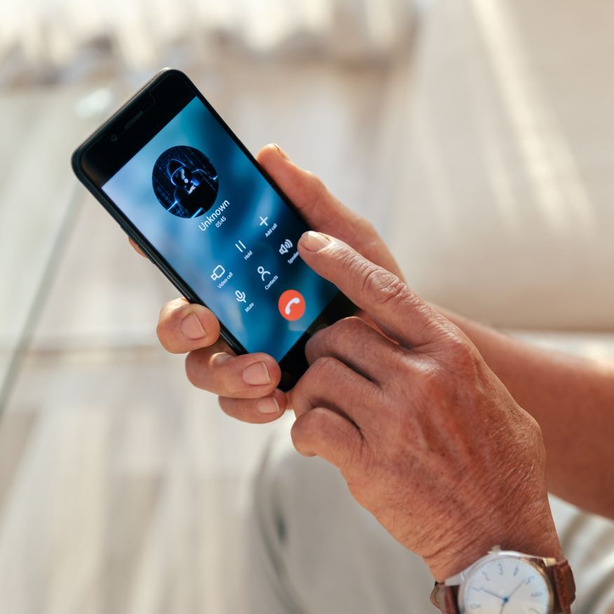 Old man accepted call with unknown person by smart phone at home