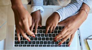 adult and child hands sharing a laptop keyboard